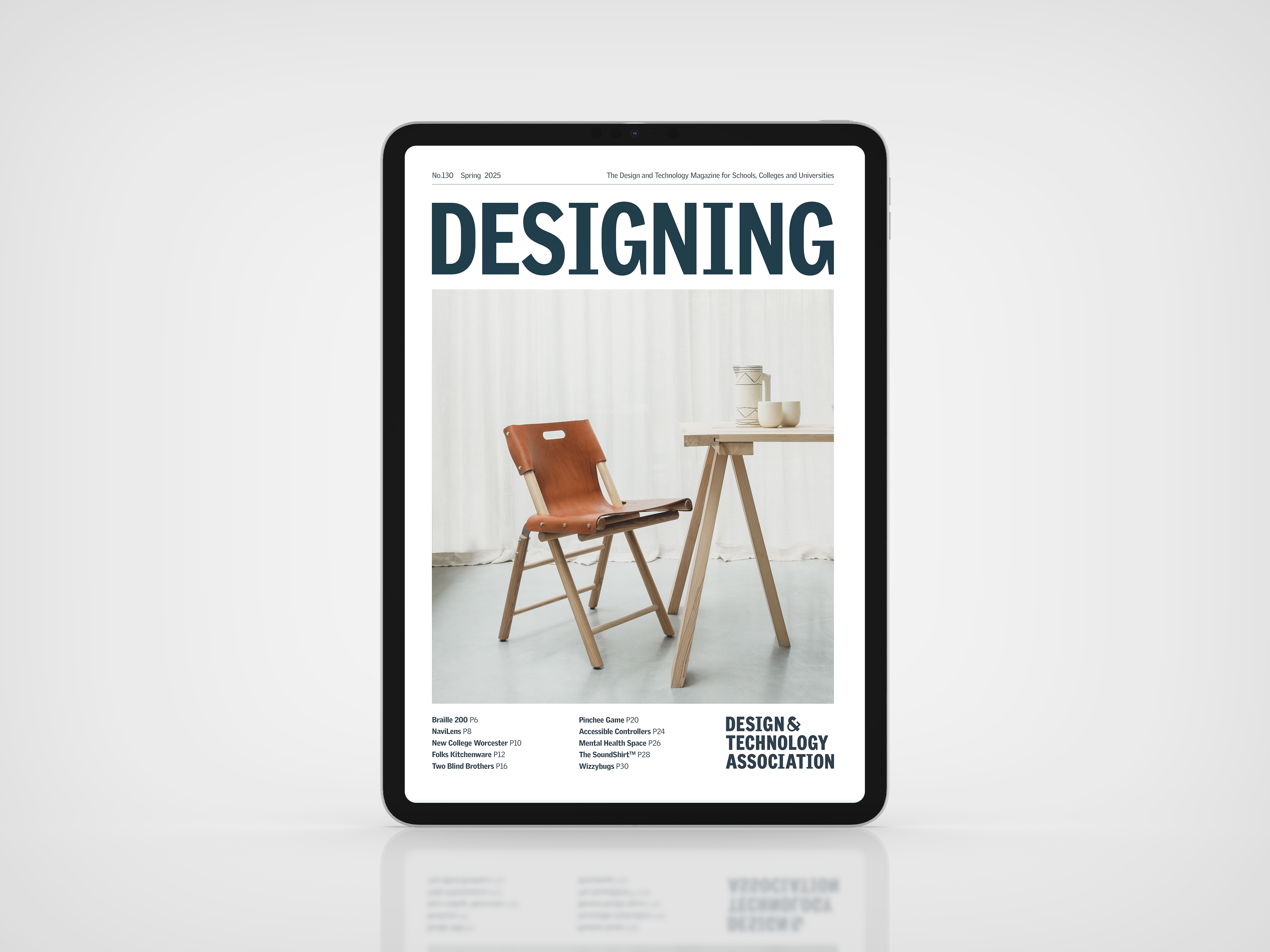Tablet mock-up showing the cover of Designing magazine (Spring 2025), featuring a wooden chair and table.