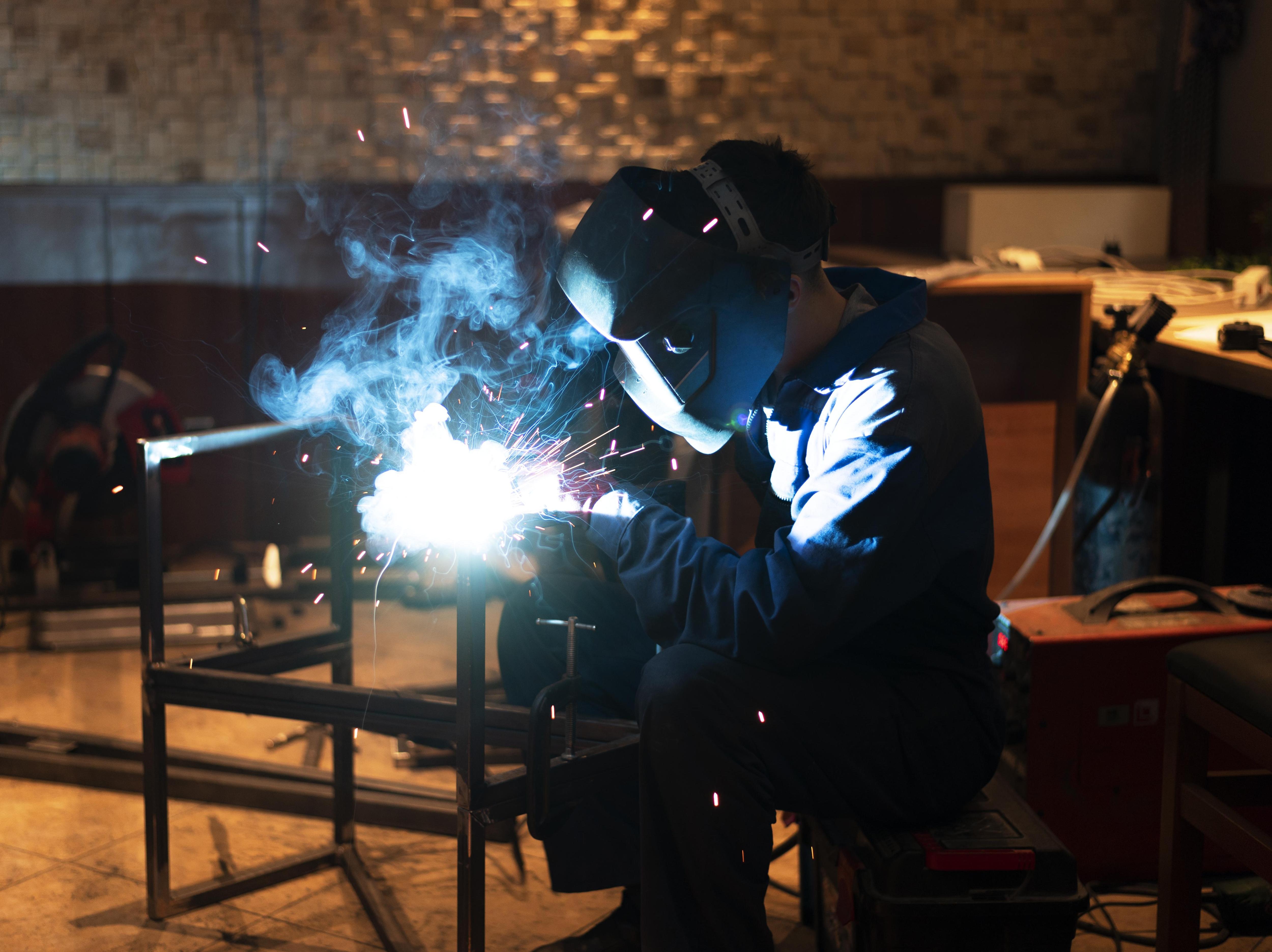 Man welding wearing a mask