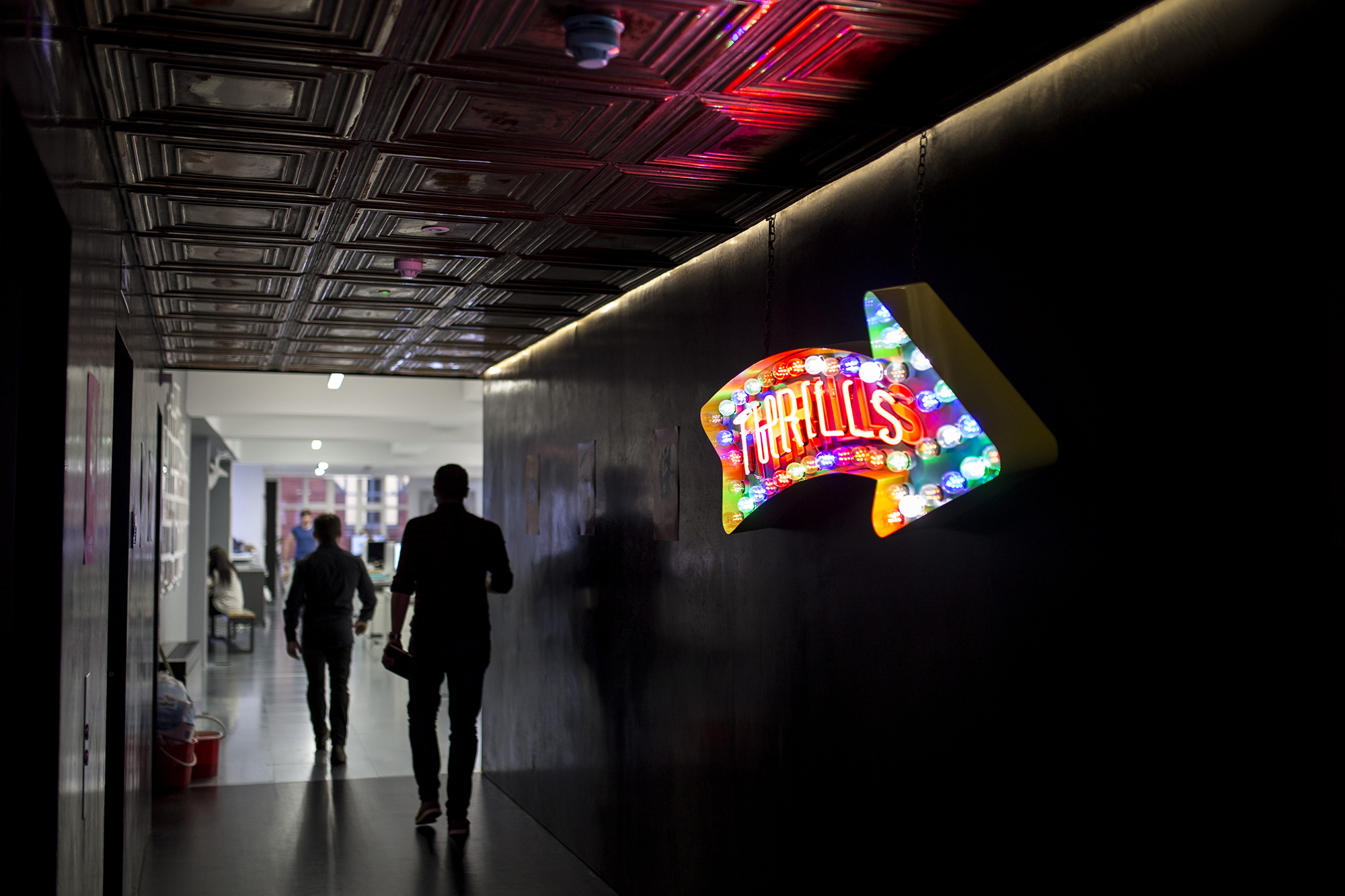 Neon sign at Bulletproof office that says 'Thrills'