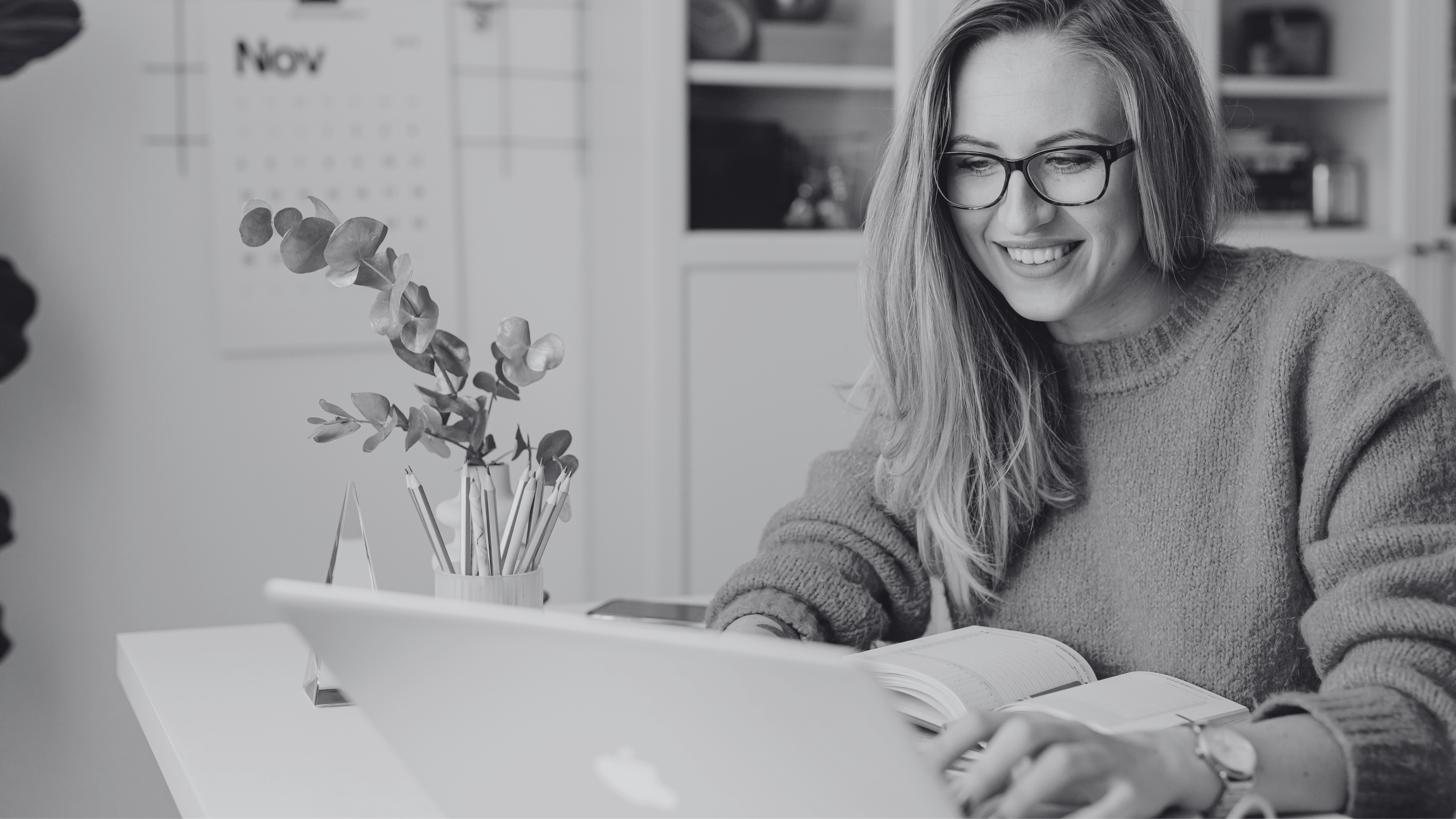 Blonde woman working on a laptop