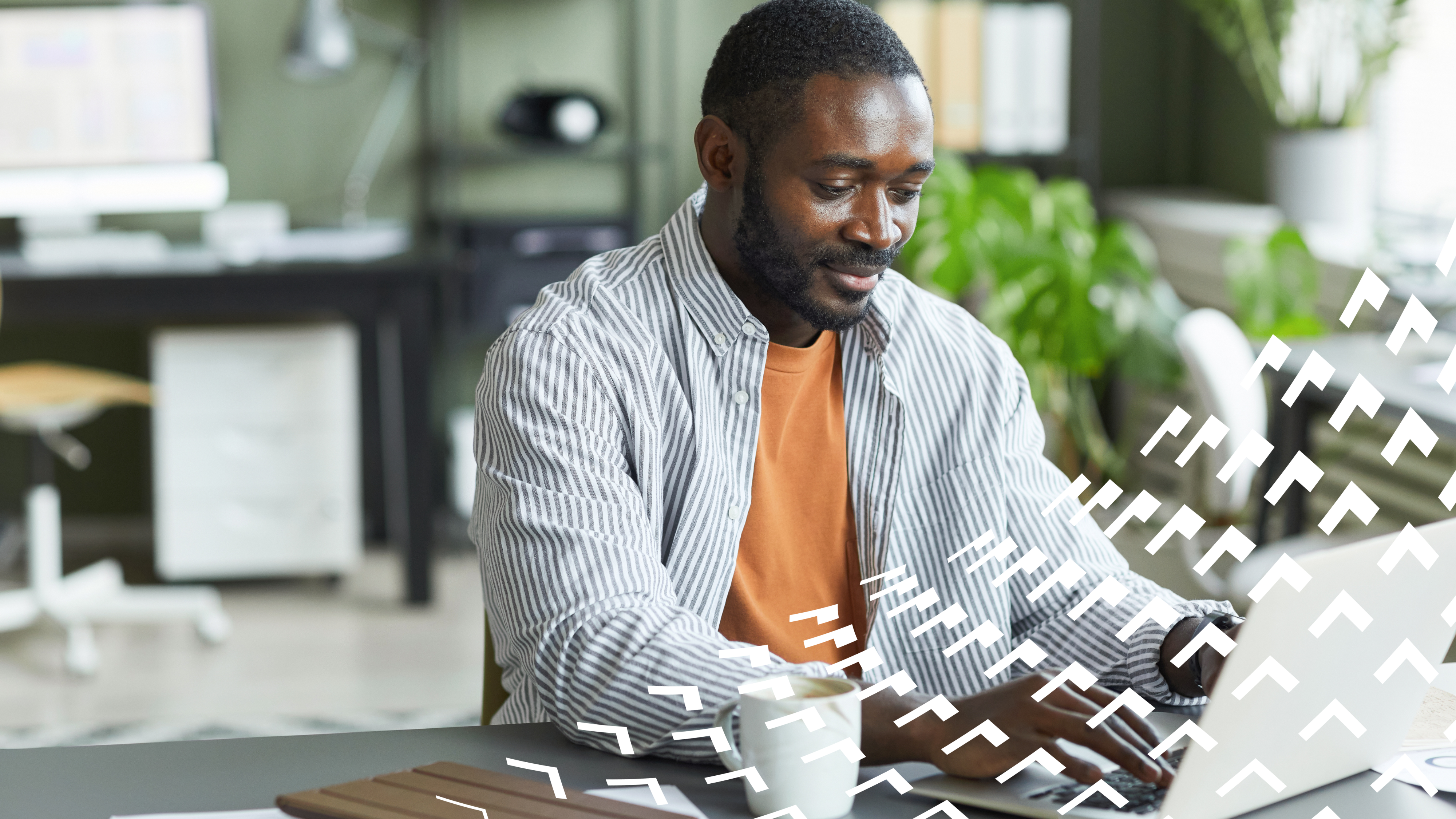 Man working at a desk on his laptop