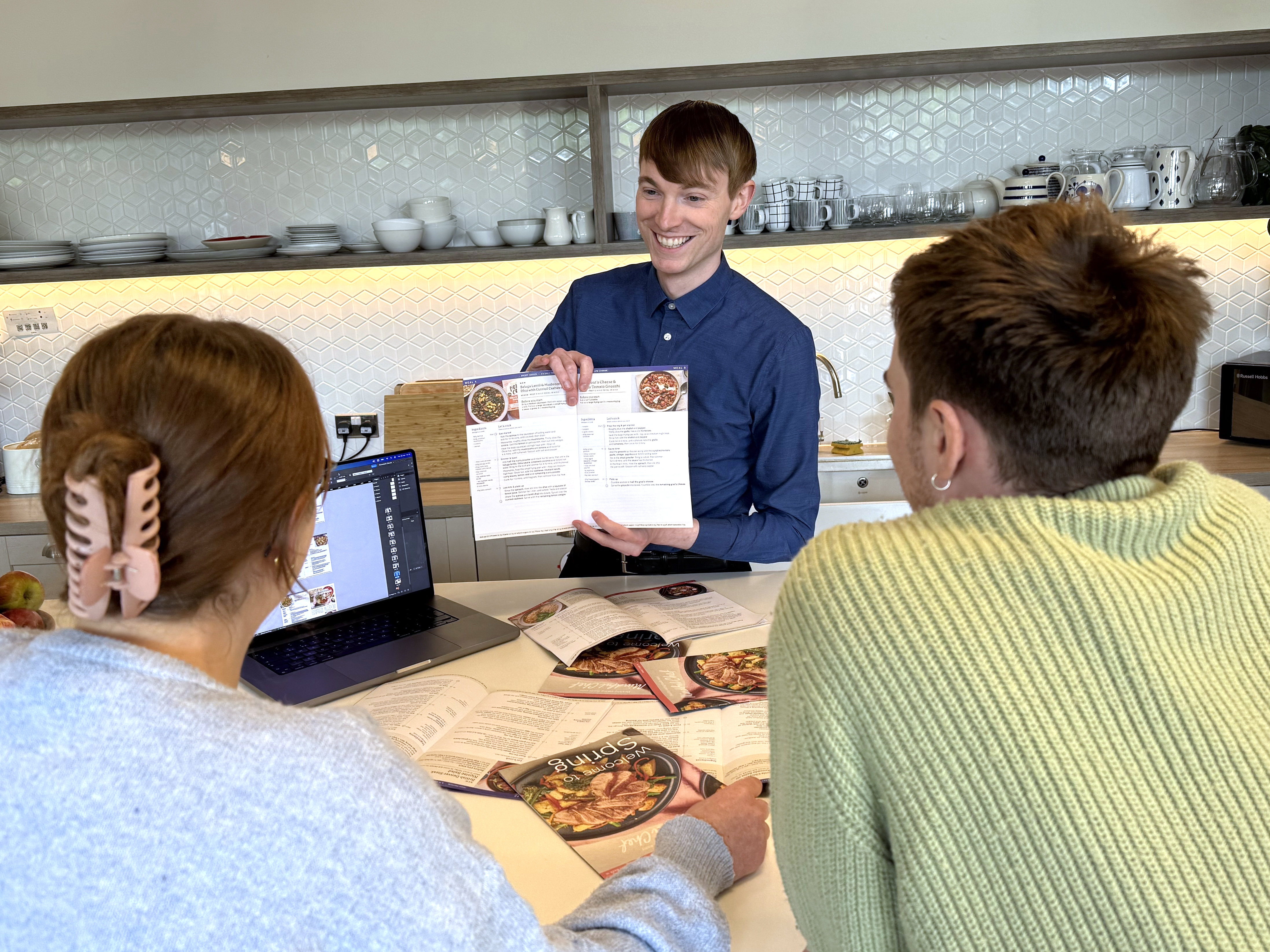 Presenting recipe materials to teachers around a table 