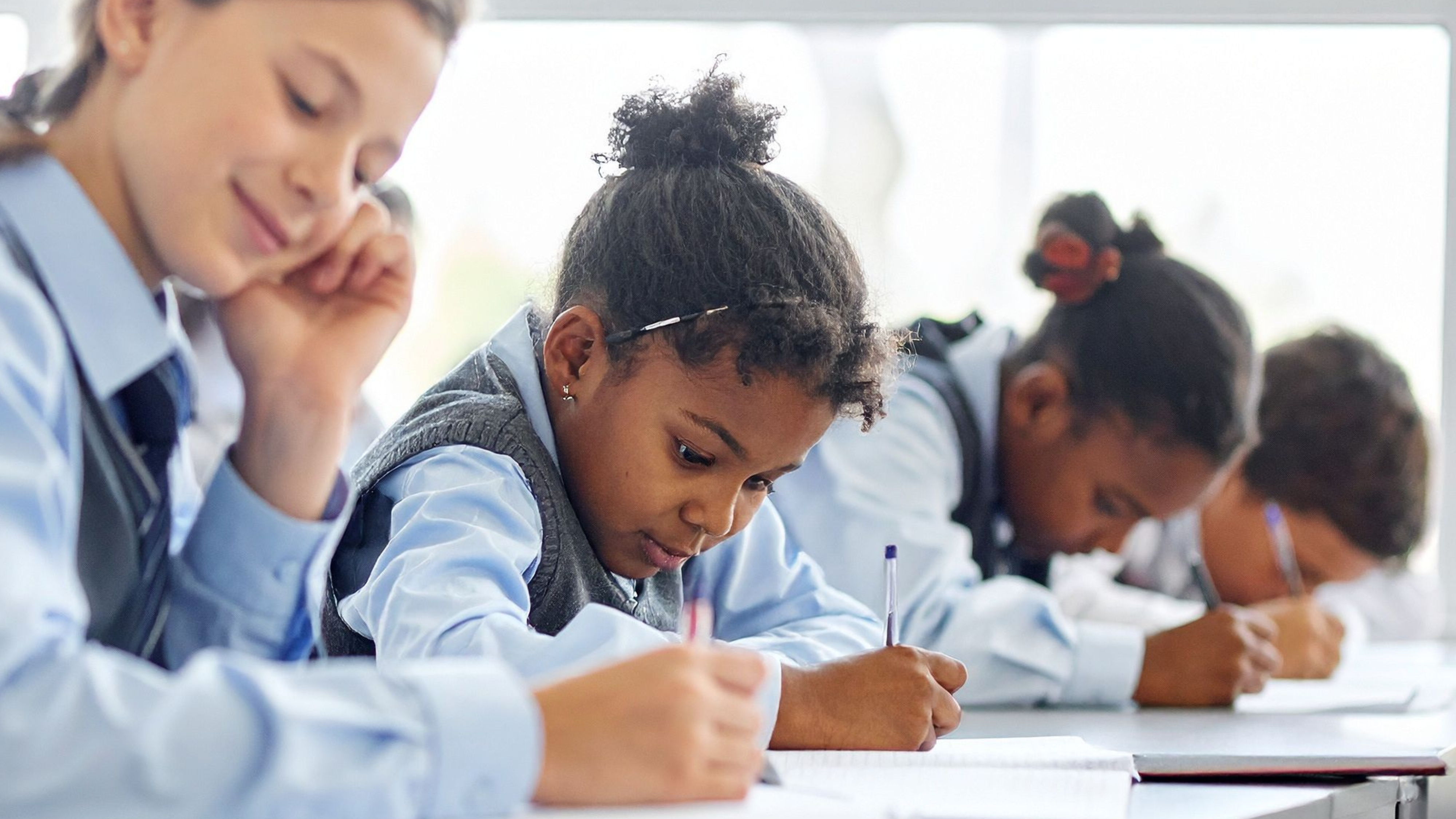 Female students writing in calss