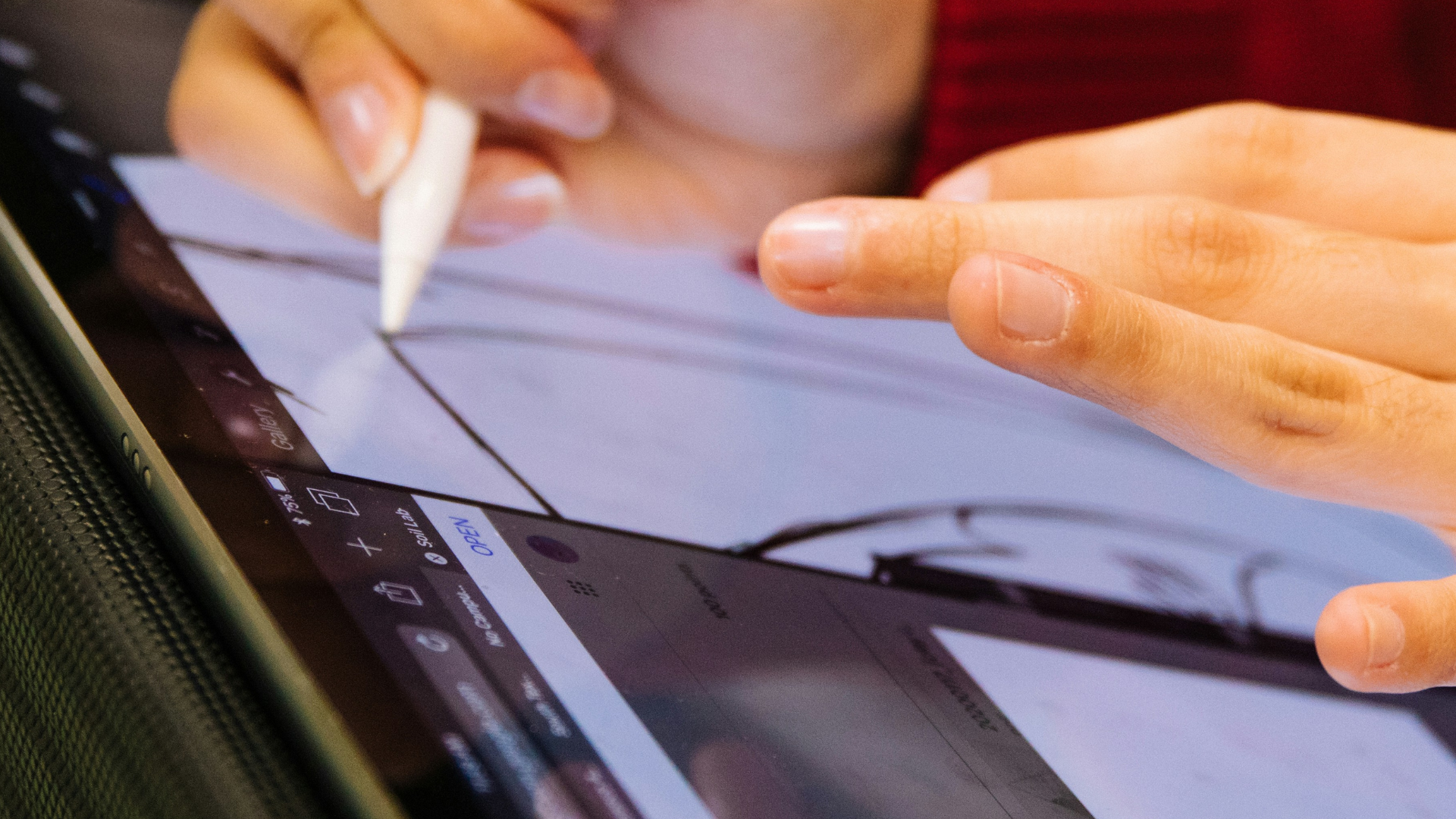Hands using a stylus on a tablet to create a digital sketch as part of the design development process.