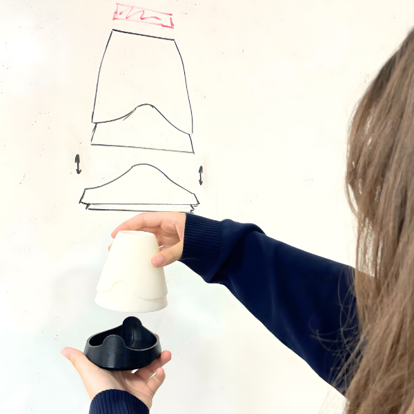 Student testing prototype components during product design process
