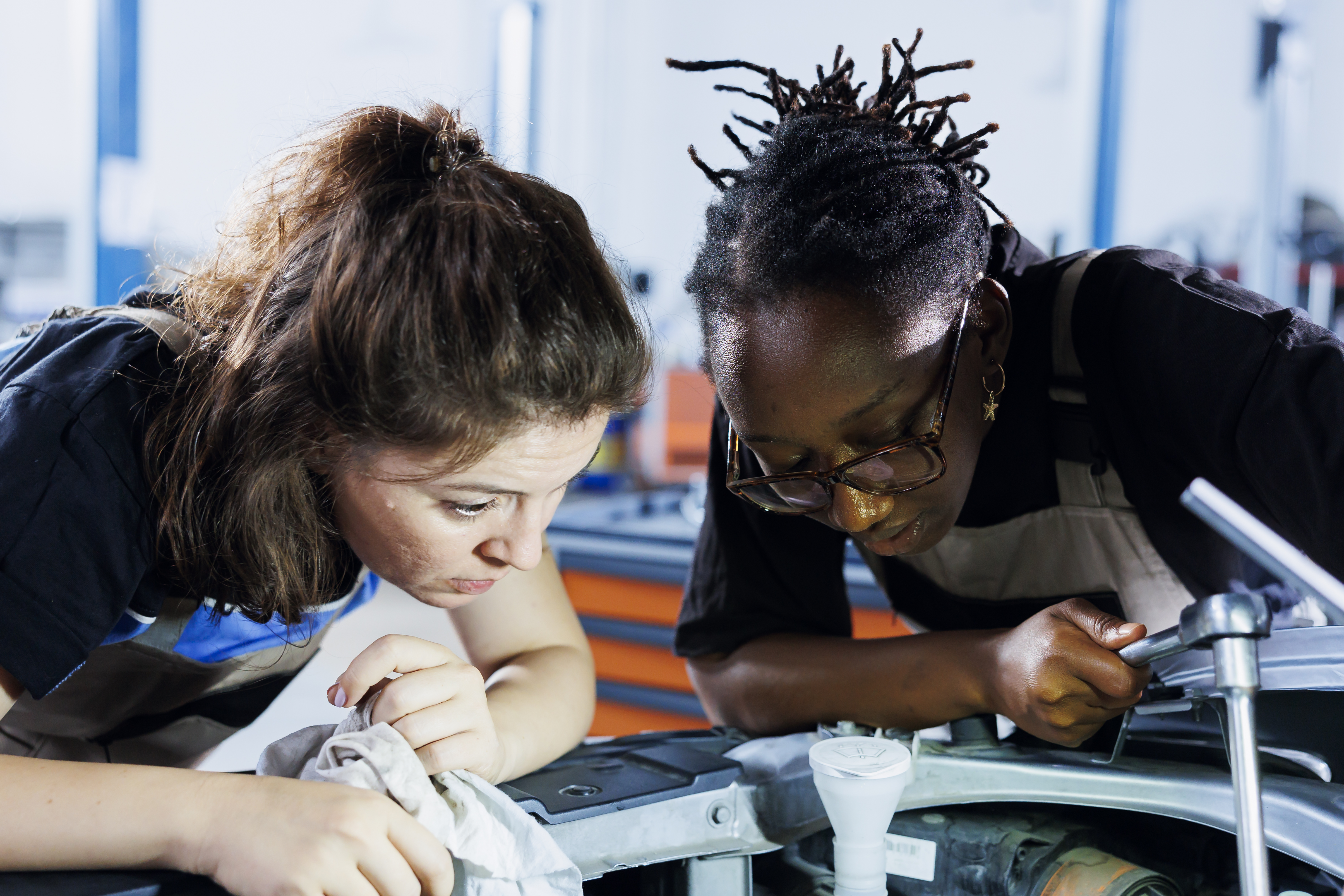 Female engineers working on a vehicle 