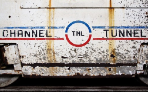 The image shows a train car with the words “channel tunnel” written on its side.