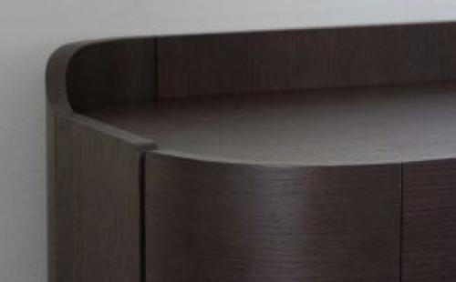 Close-up of curved wooden furniture showing smooth edges 